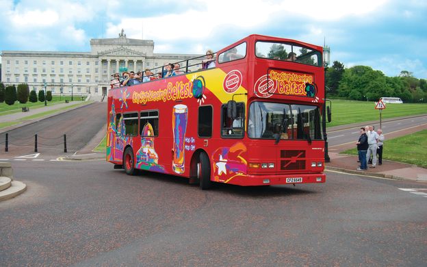 Tranquil journey through Belfast's streets: City Sightseeing Hop-on Hop-off bus offers passengers serene vibes, exploring the city's charm.